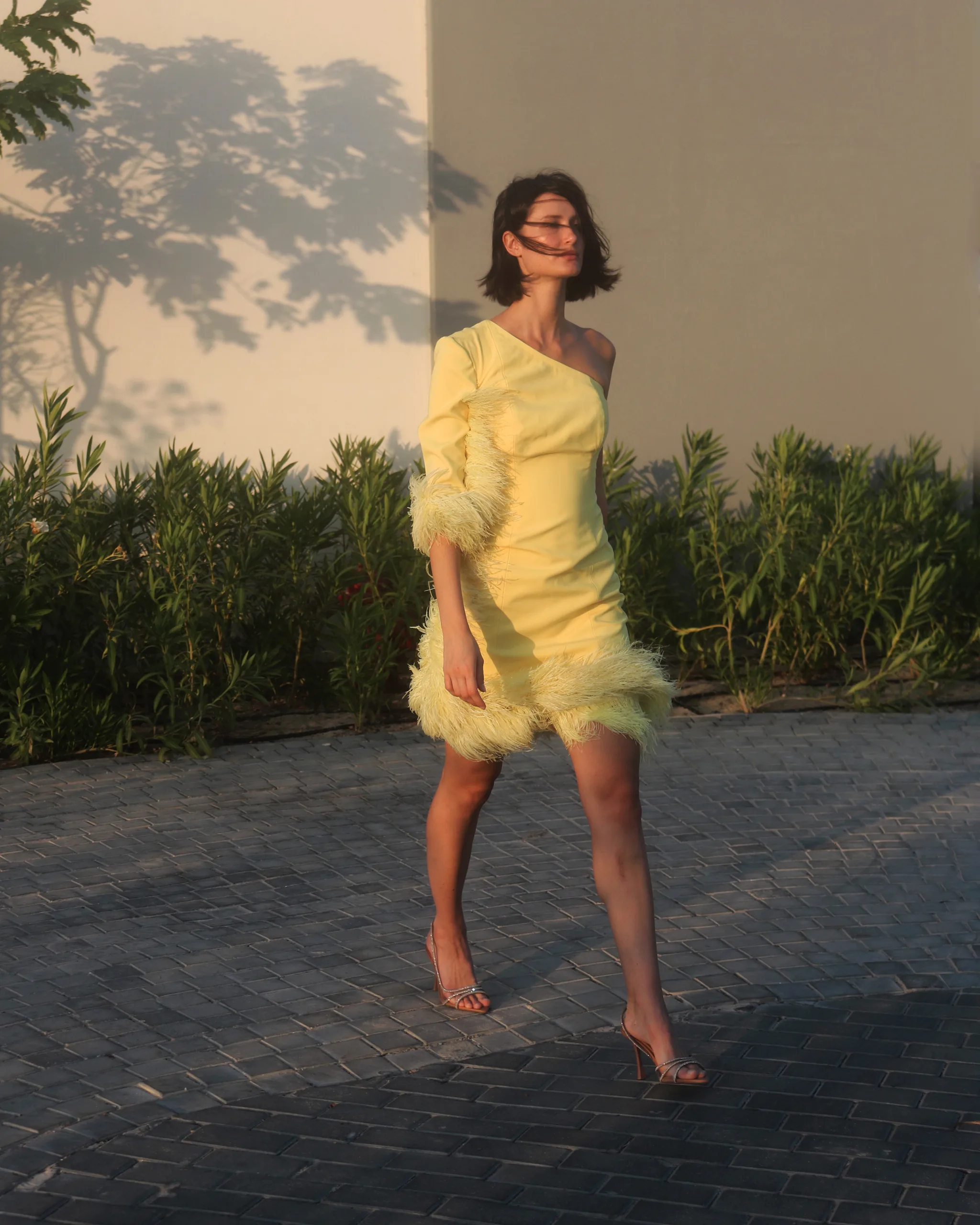 Model walking in a yellow feathered dress